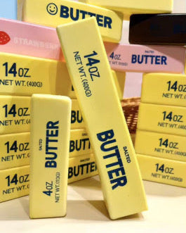 Multiple boxes of 'BUTTER' squishies brand product with visible branding