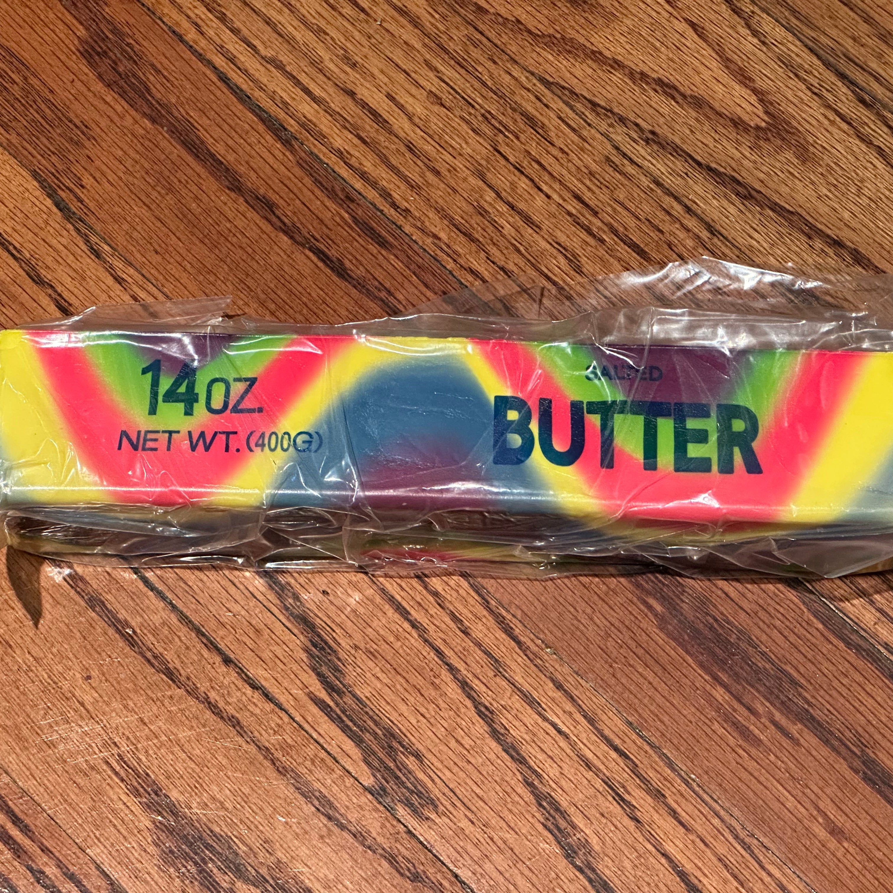 a giant 14oz rainbow slow-rising salted butter-stick squishy with realistic labeling, and an oversized shape