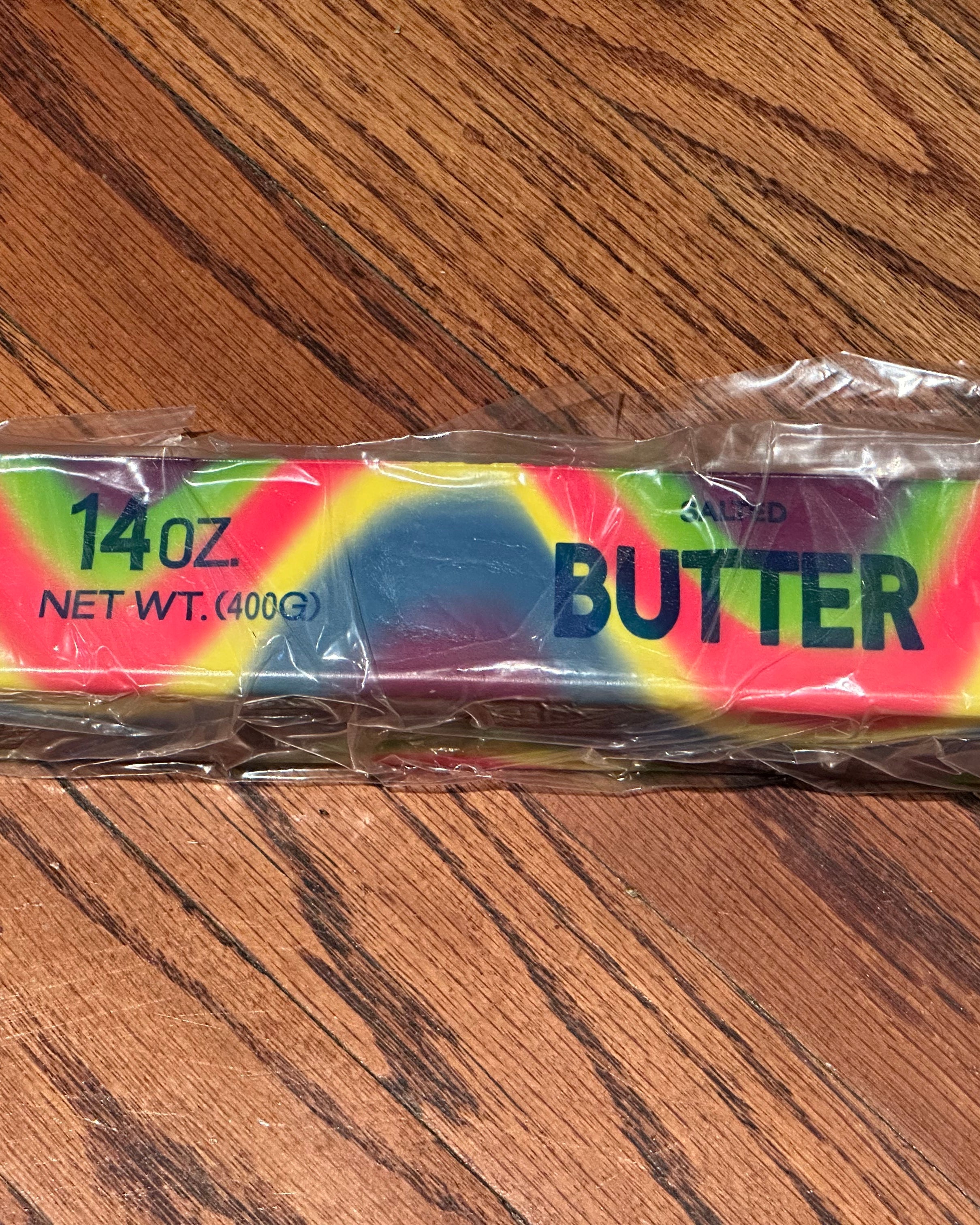 a giant 14oz rainbow slow-rising salted butter-stick squishy with realistic labeling, and an oversized shape