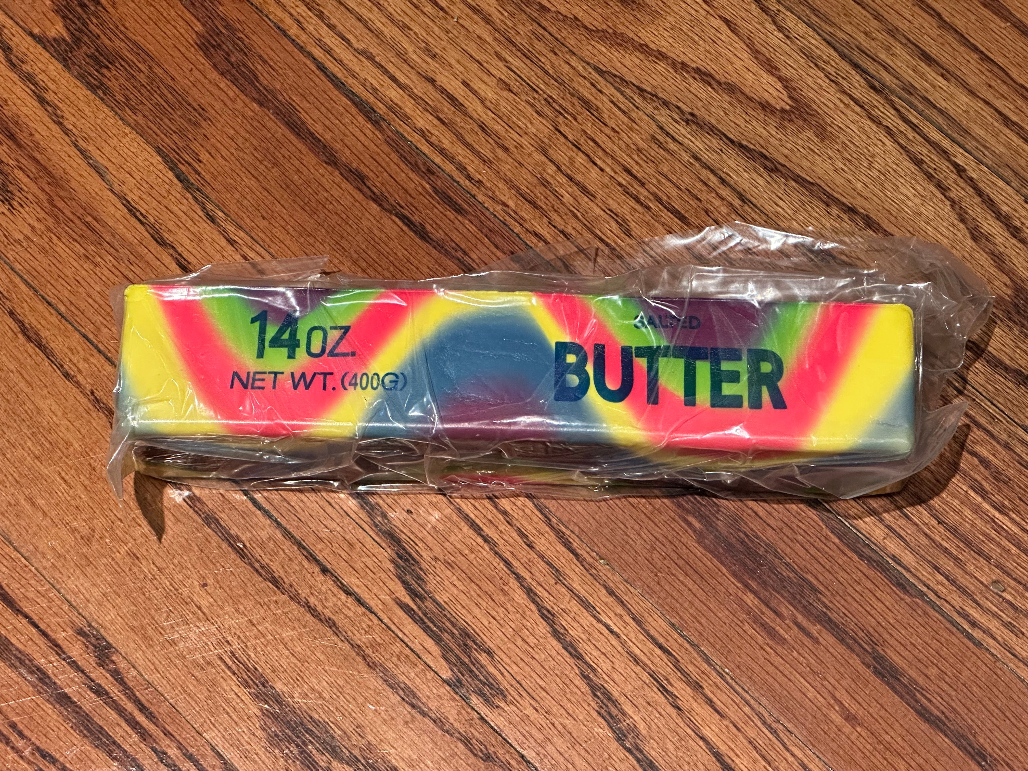a giant 14oz rainbow slow-rising salted butter-stick squishy with realistic labeling, and an oversized shape