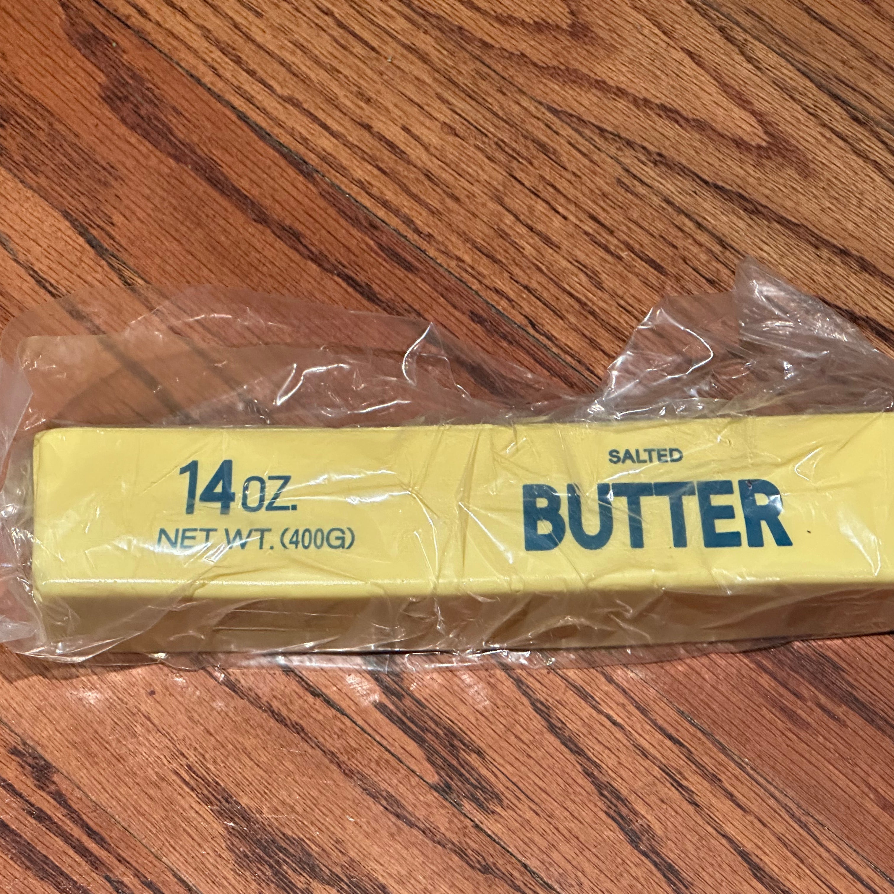 a giant 14oz yellow slow-rising salted butter-stick squishy with realistic labeling, and an oversized shape