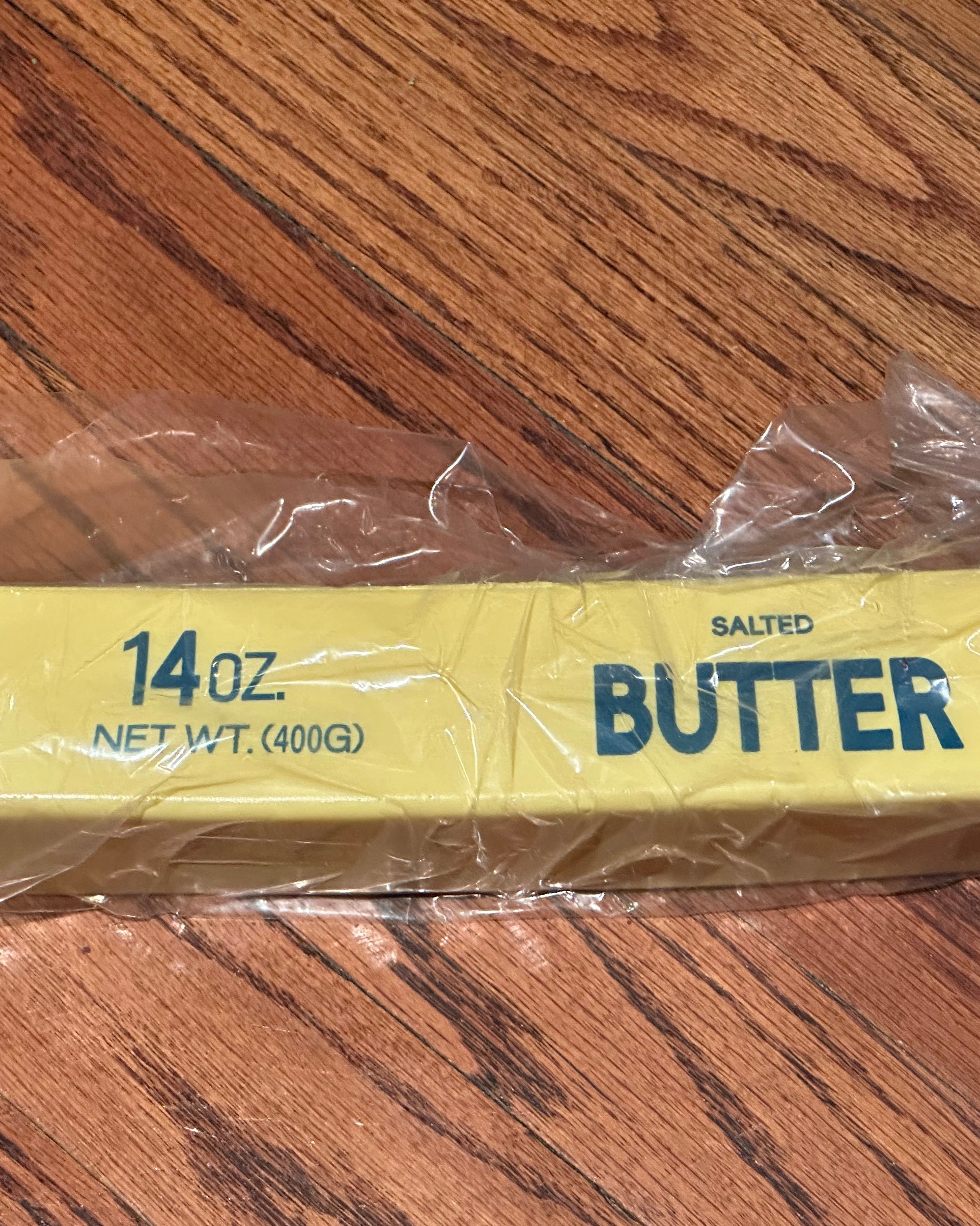 a giant 14oz yellow slow-rising salted butter-stick squishy with realistic labeling, and an oversized shape