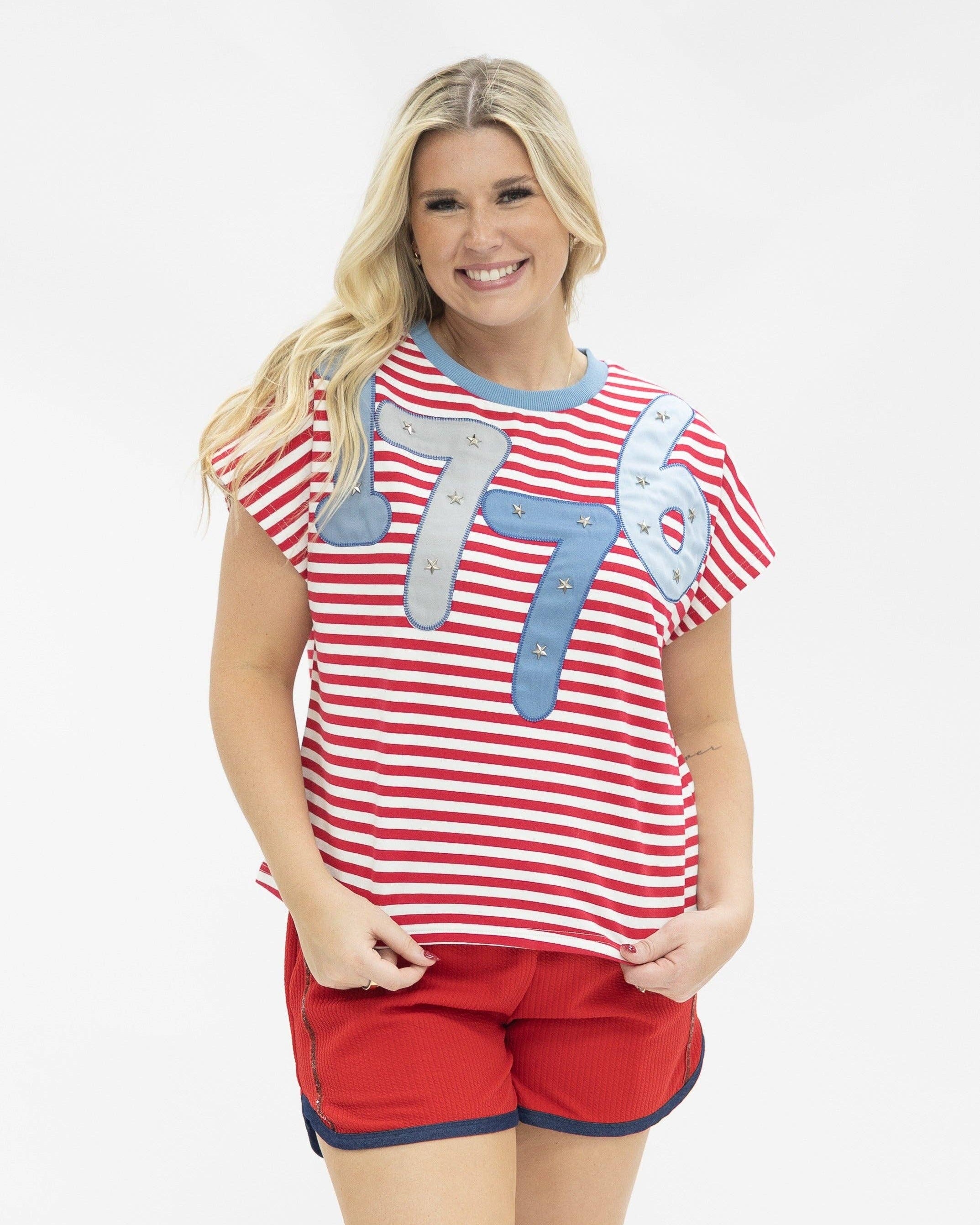 a high-stretch oversized short-sleeve stripe top with a crew neckline, a horizontal stripe pattern (red and white), bold denim 1776 patch detail, tiny star accents, a relaxed easy drape, and unlined