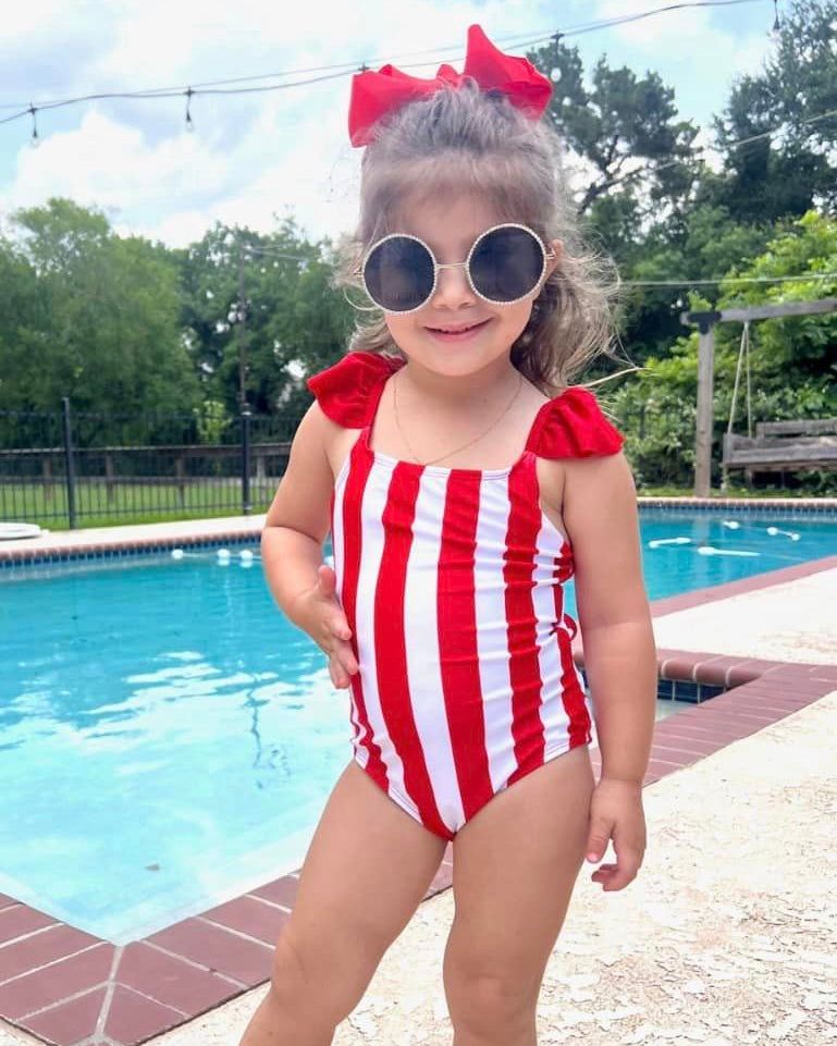 red and white vertical stripe one-piece swimsuit with ruffle sleeves and a criss-cross back