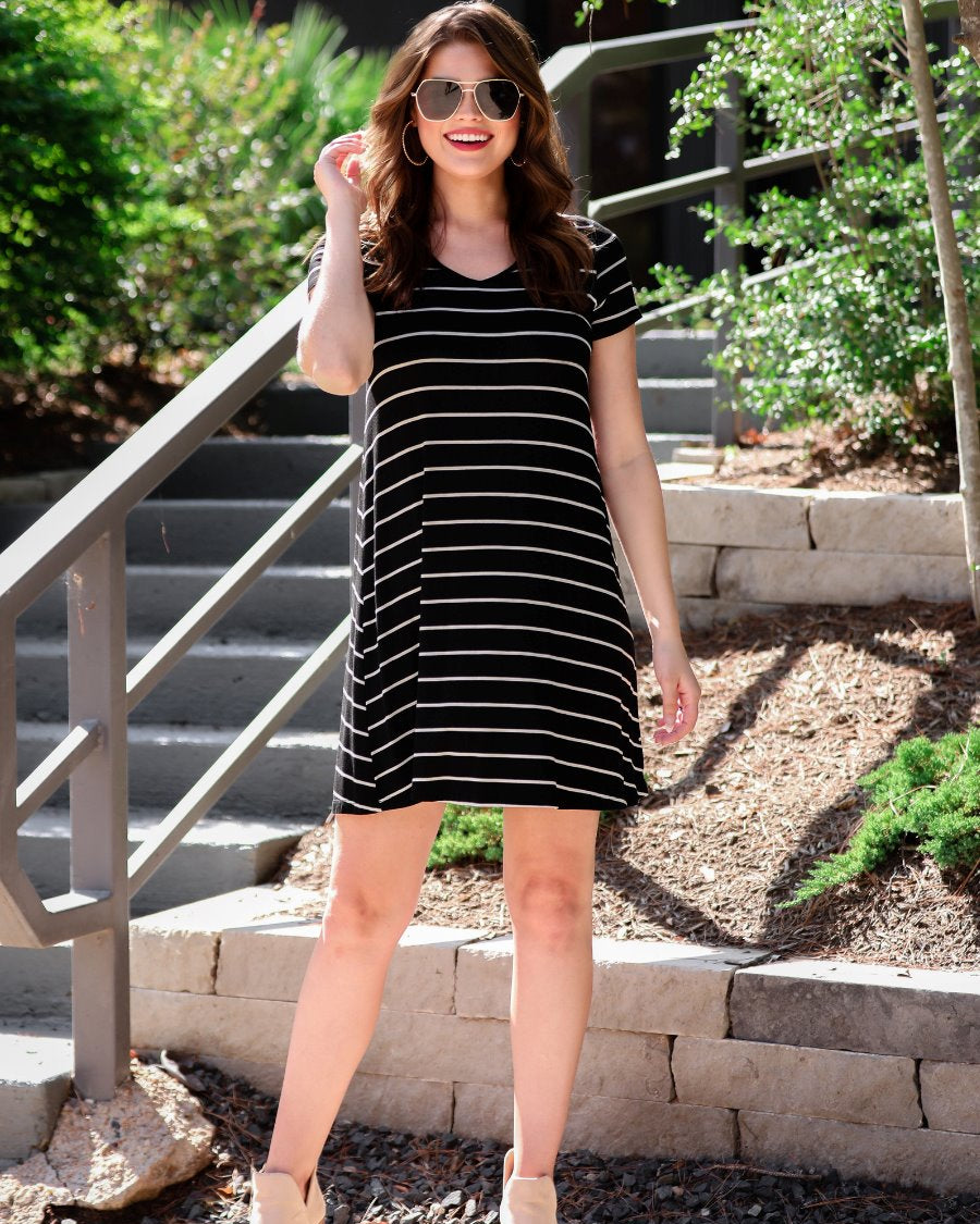 short-sleeve A-line dress with a V-neckline, crafted from ultra-soft fabric in a solid color with horizontal white stripes and a straight hemline in black