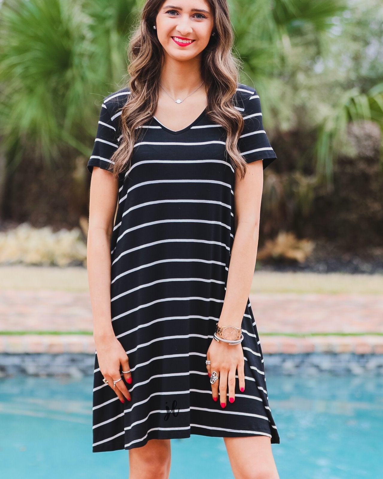 short-sleeve A-line dress with a V-neckline, crafted from ultra-soft fabric in a solid color with horizontal white stripes and a straight hemline in black