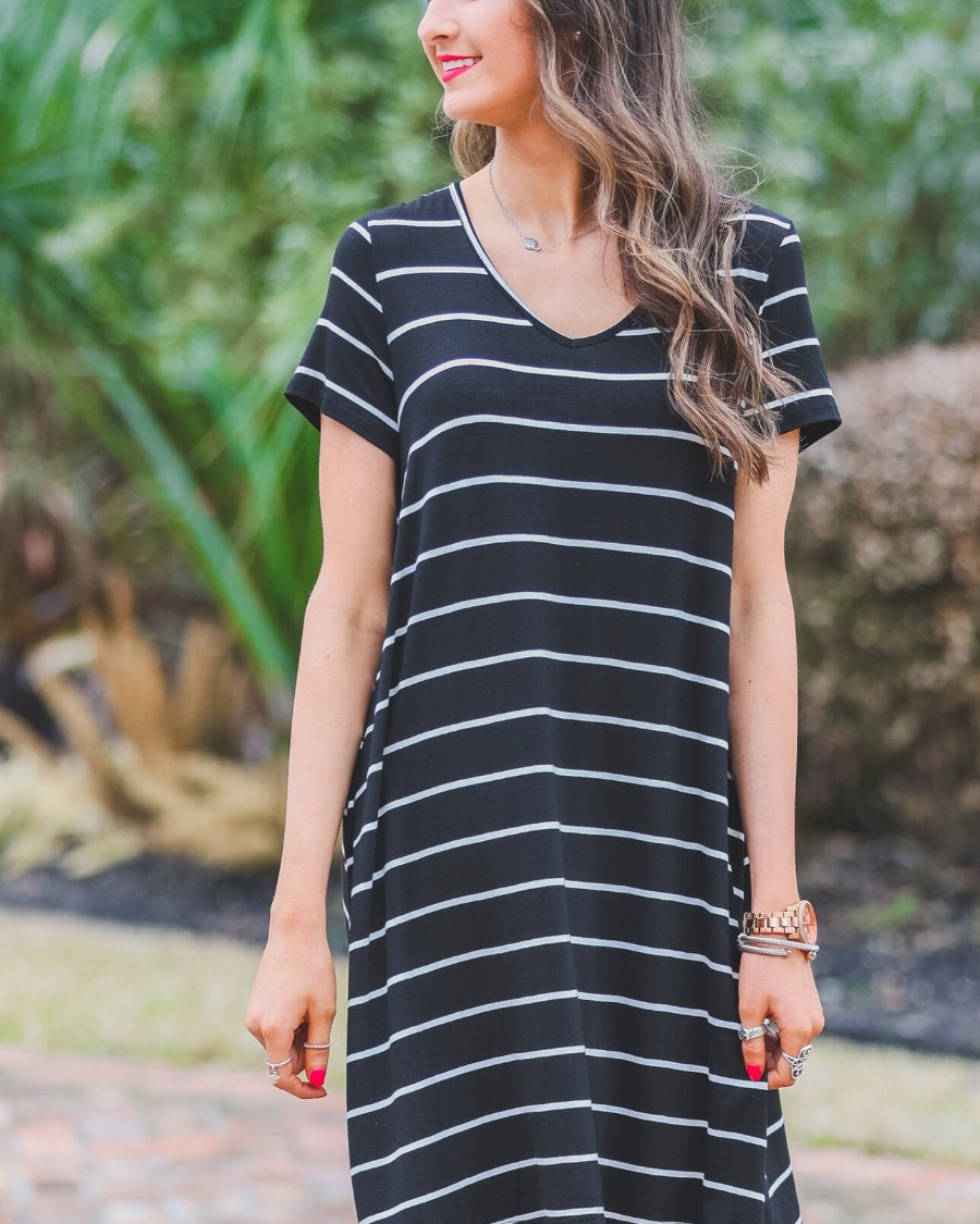 short-sleeve A-line dress with a V-neckline, crafted from ultra-soft fabric in a solid color with horizontal white stripes and a straight hemline in black