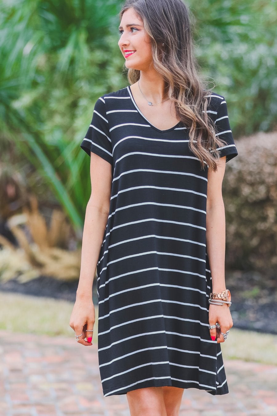 short-sleeve A-line dress with a V-neckline, crafted from ultra-soft fabric in a solid color with horizontal white stripes and a straight hemline in black