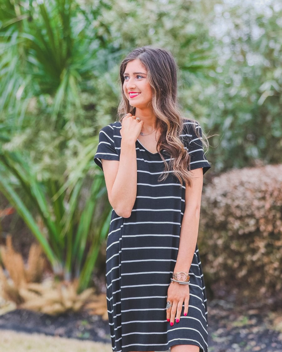 short-sleeve A-line dress with a V-neckline, crafted from ultra-soft fabric in a solid color with horizontal white stripes and a straight hemline in black
