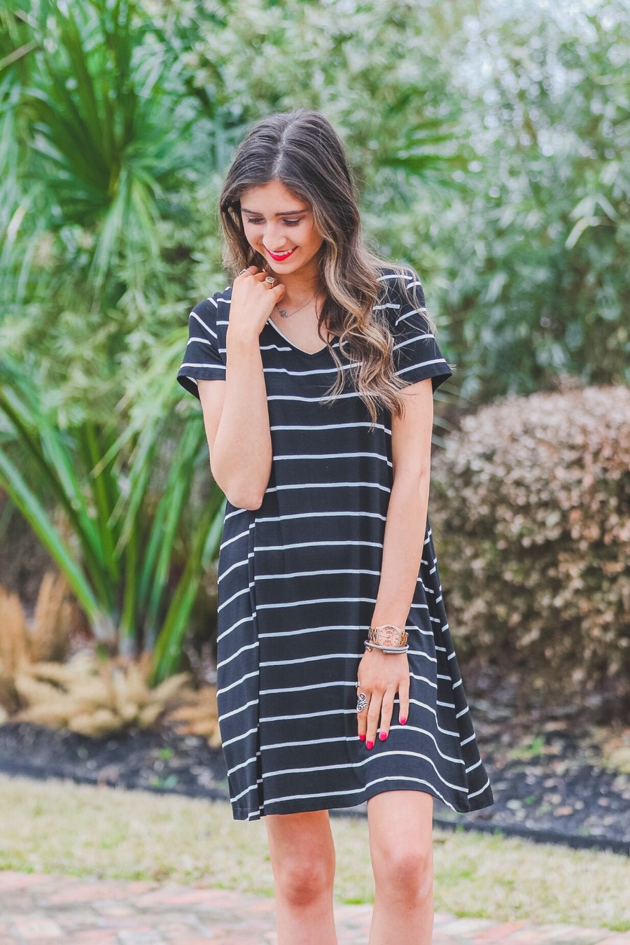short-sleeve A-line dress with a V-neckline, crafted from ultra-soft fabric in a solid color with horizontal white stripes and a straight hemline in black