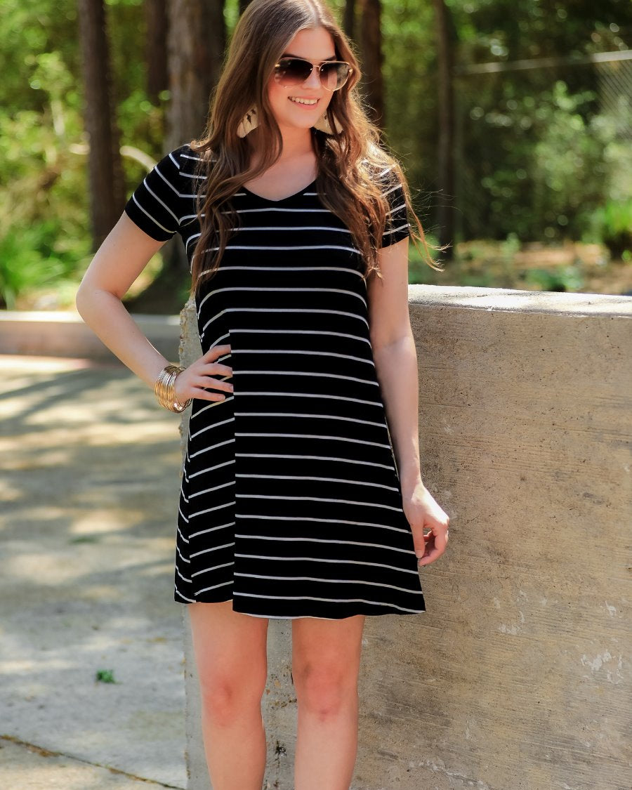 short-sleeve A-line dress with a V-neckline, crafted from ultra-soft fabric in a solid color with horizontal white stripes and a straight hemline in black
