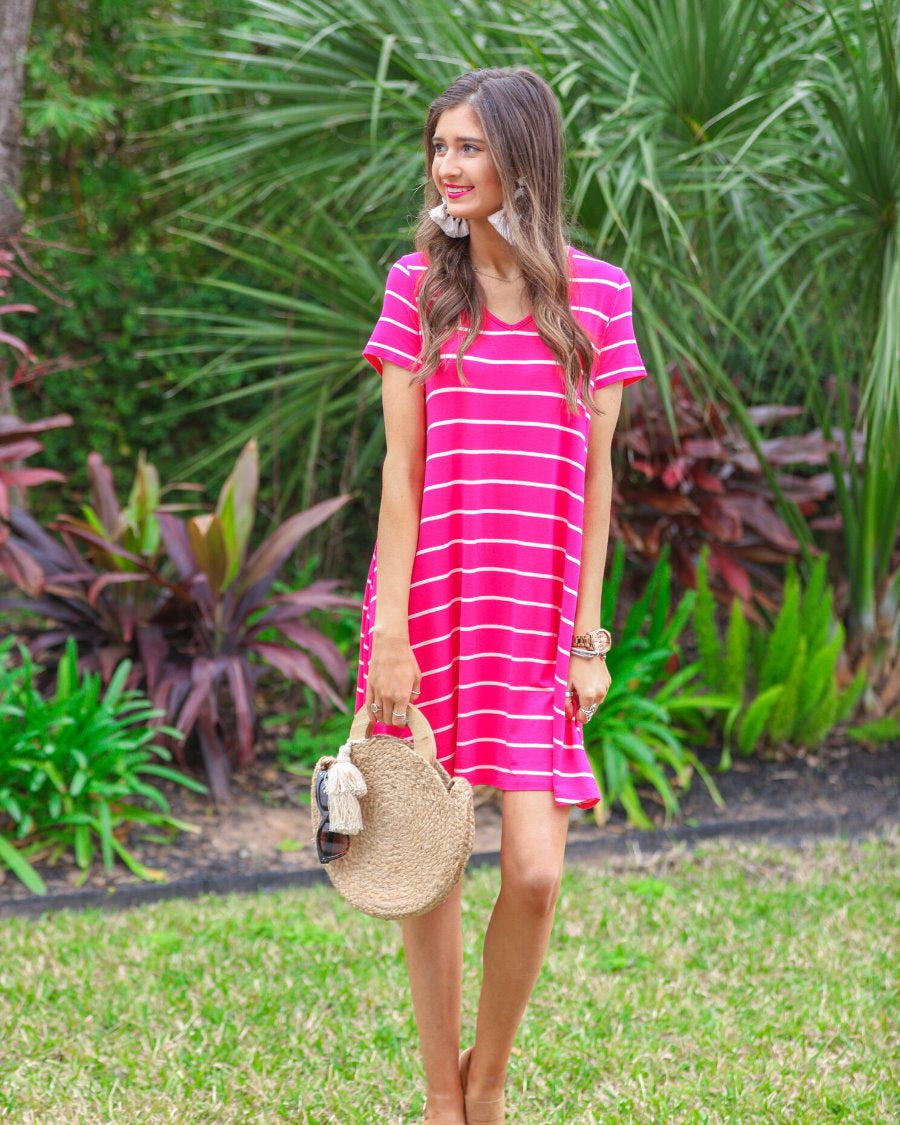 short-sleeve A-line dress with a V-neckline, crafted from ultra-soft fabric in a solid color with horizontal white stripes and a straight hemline in hot pink