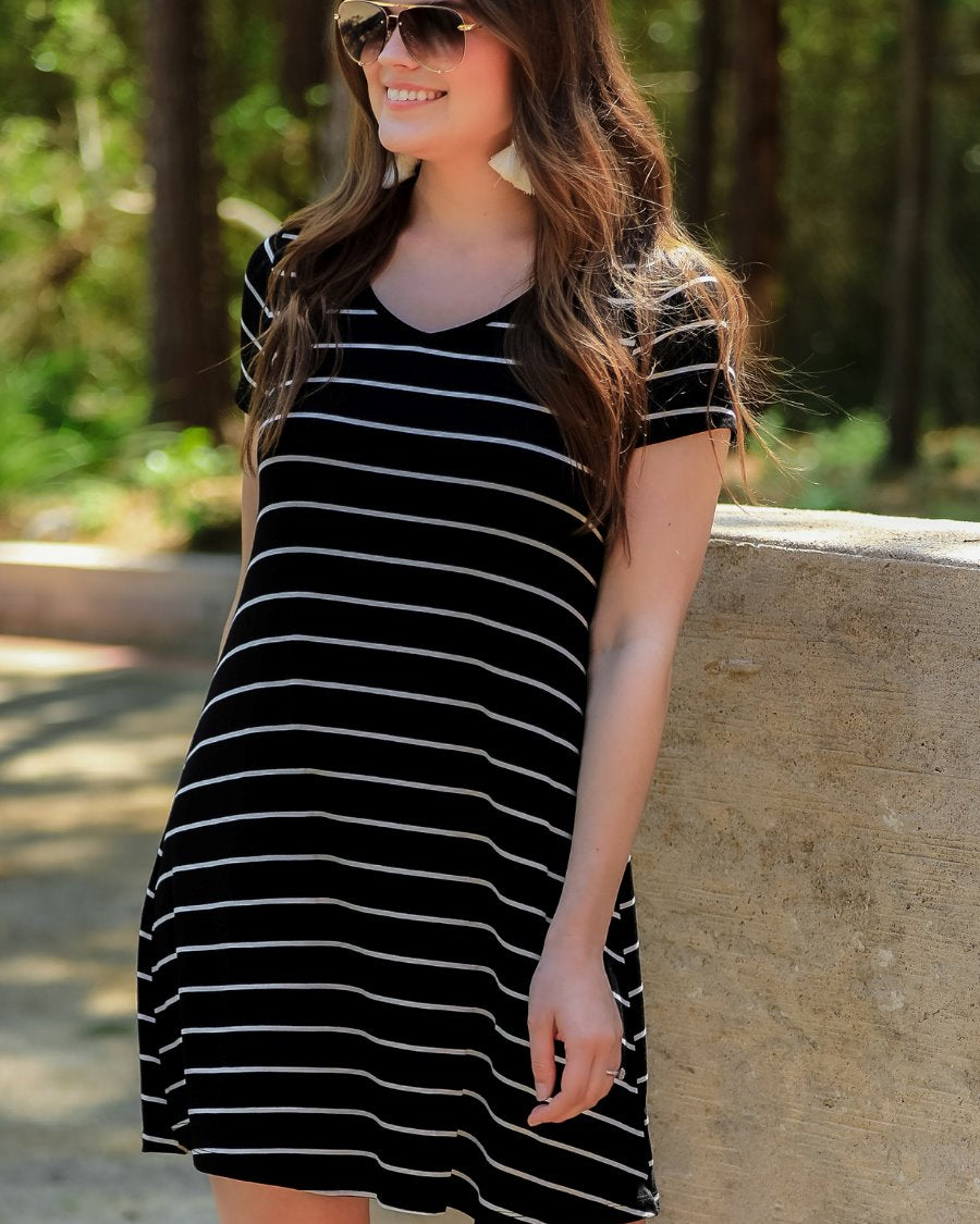 short-sleeve A-line dress with a V-neckline, crafted from ultra-soft fabric in a solid color with horizontal white stripes and a straight hemline in black
