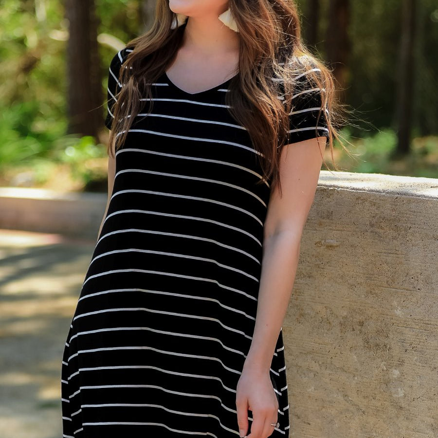 short-sleeve A-line dress with a V-neckline, crafted from ultra-soft fabric in a solid color with horizontal white stripes and a straight hemline in black