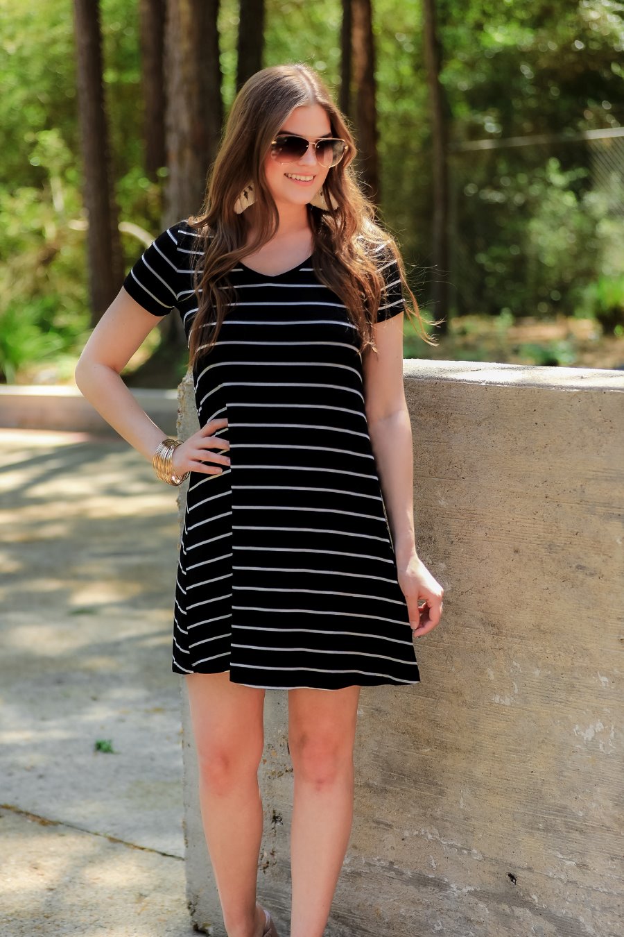 short-sleeve A-line dress with a V-neckline, crafted from ultra-soft fabric in a solid color with horizontal white stripes and a straight hemline in black