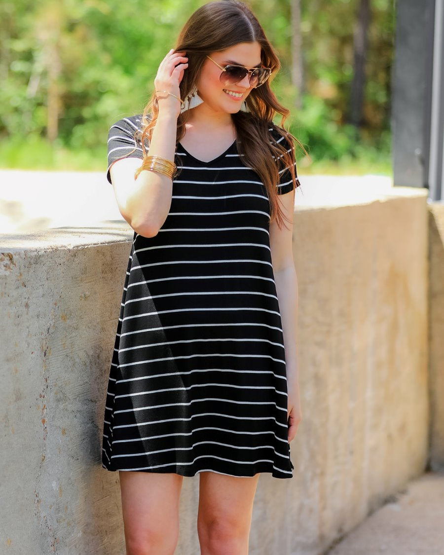 short-sleeve A-line dress with a V-neckline, crafted from ultra-soft fabric in a solid color with horizontal white stripes and a straight hemline in black