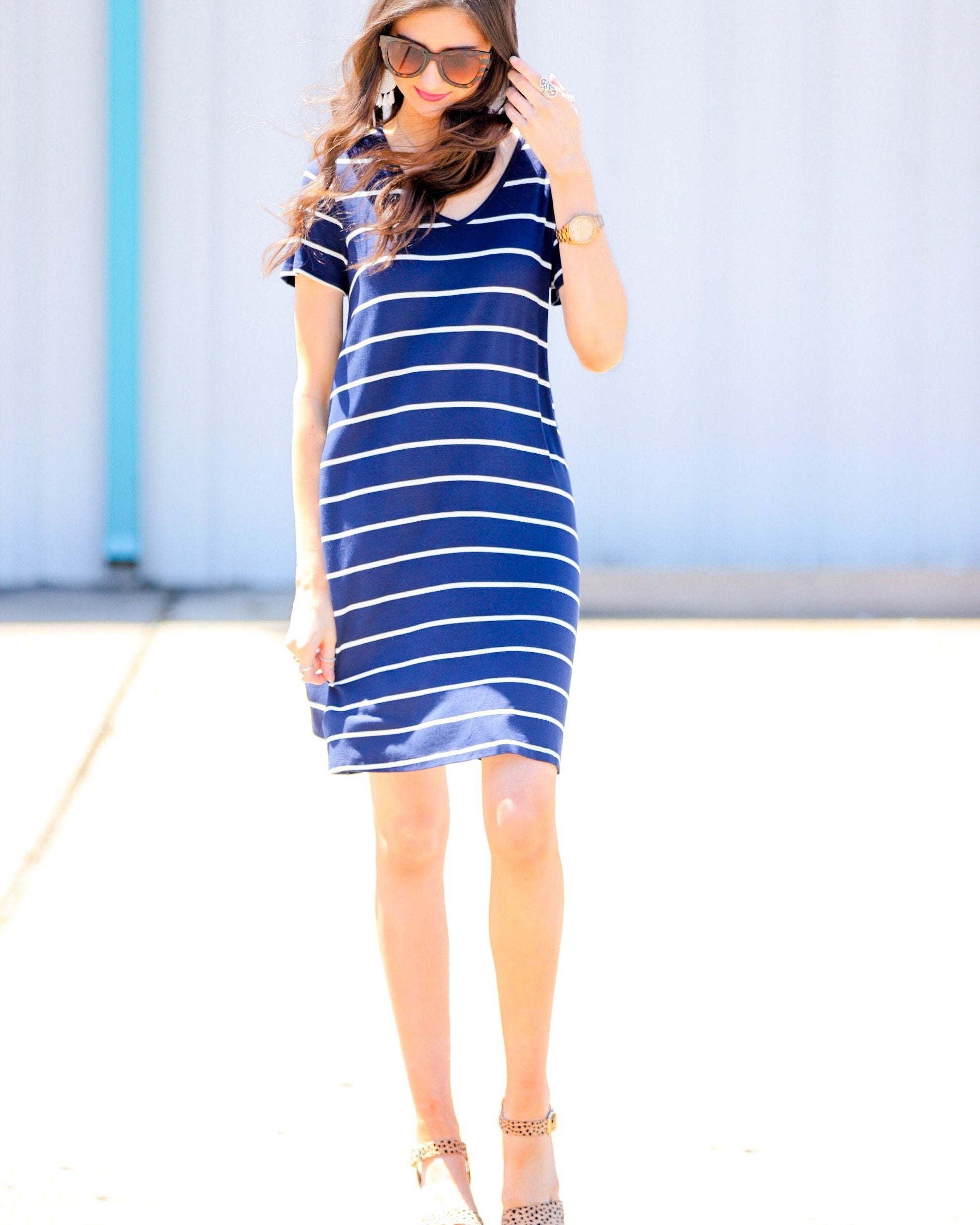 short-sleeve A-line dress with a V-neckline, crafted from ultra-soft fabric in a solid color with horizontal white stripes and a straight hemline in navy