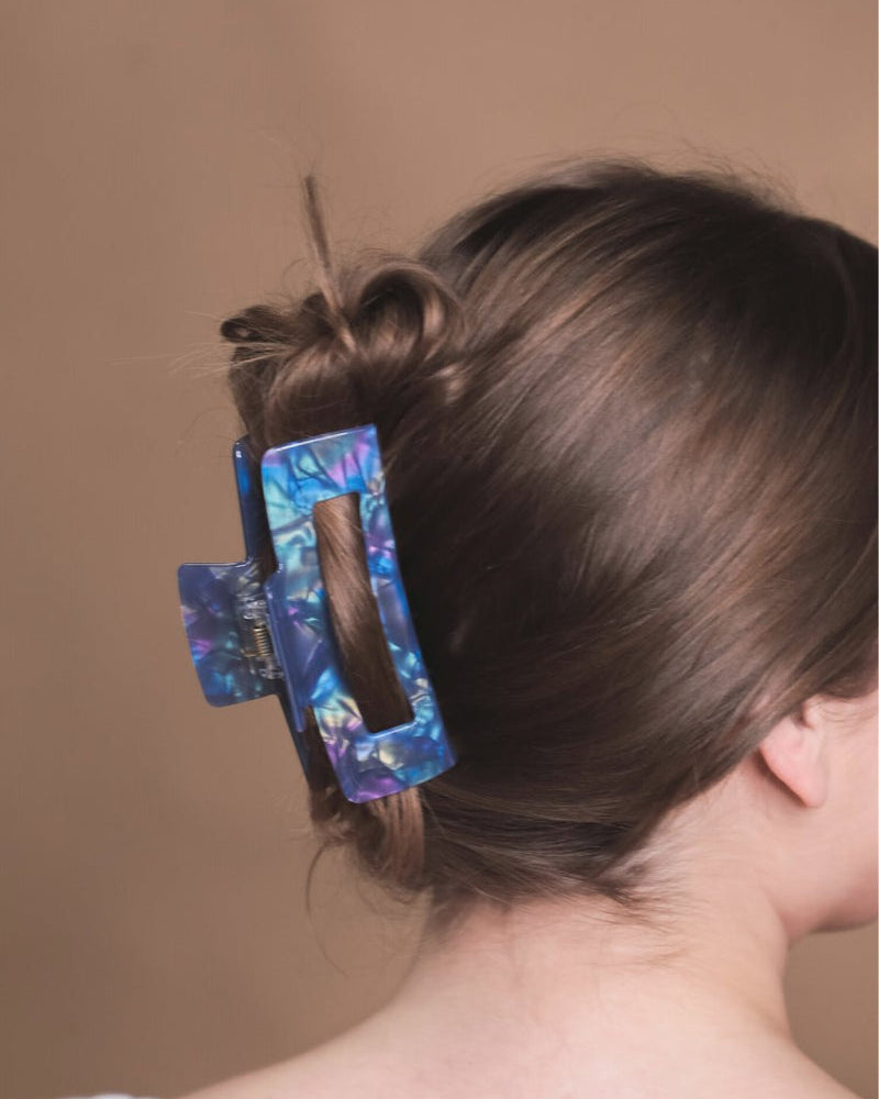 marble acrylic claw clip with a gentle grip that reduces breakage while providing a secure hold in blue