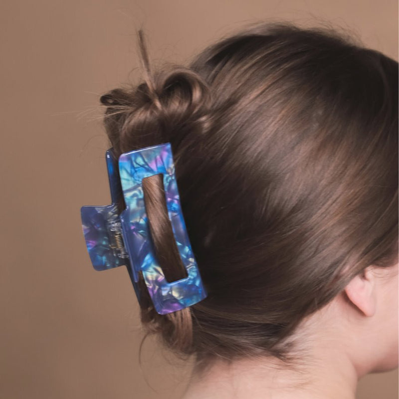 marble acrylic claw clip with a gentle grip that reduces breakage while providing a secure hold in blue