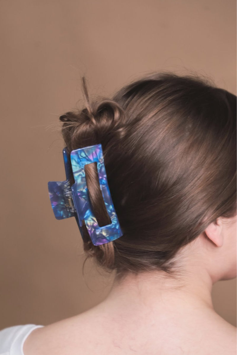 marble acrylic claw clip with a gentle grip that reduces breakage while providing a secure hold in blue