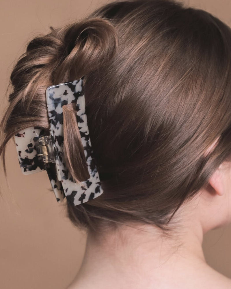 marble acrylic claw clip with a gentle grip that reduces breakage while providing a secure hold in tan