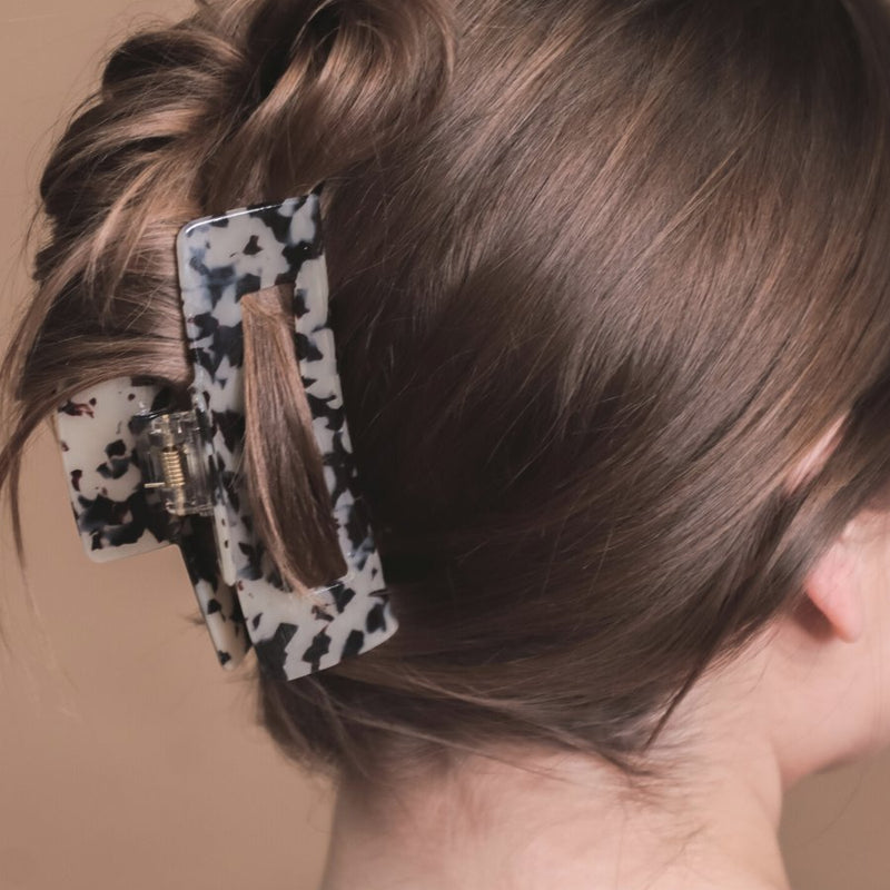 marble acrylic claw clip with a gentle grip that reduces breakage while providing a secure hold in tan