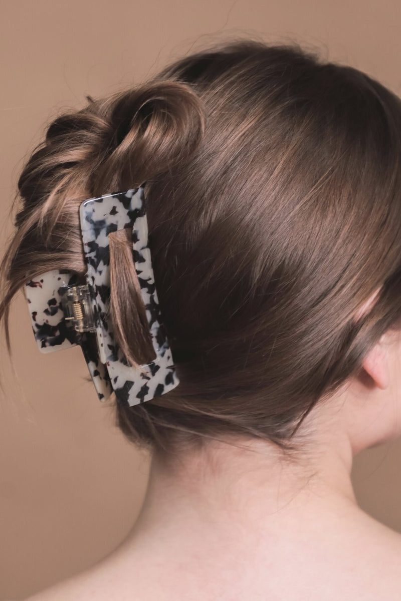 marble acrylic claw clip with a gentle grip that reduces breakage while providing a secure hold in tan