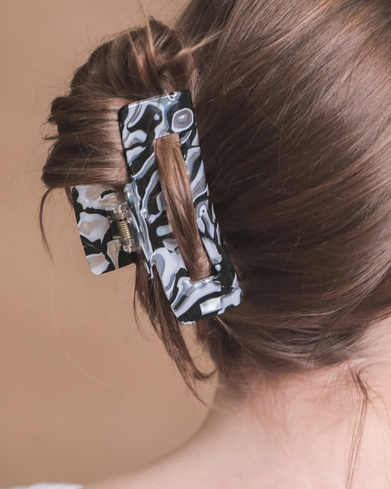 marble acrylic claw clip with a gentle grip that reduces breakage while providing a secure hold in white