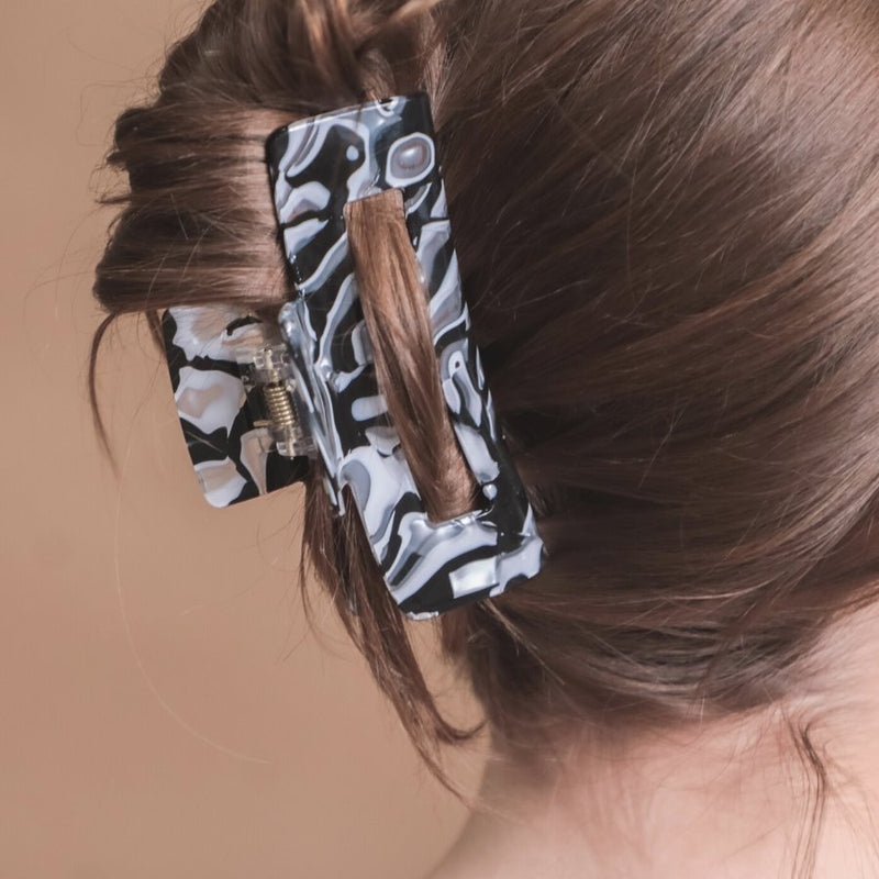 marble acrylic claw clip with a gentle grip that reduces breakage while providing a secure hold in white