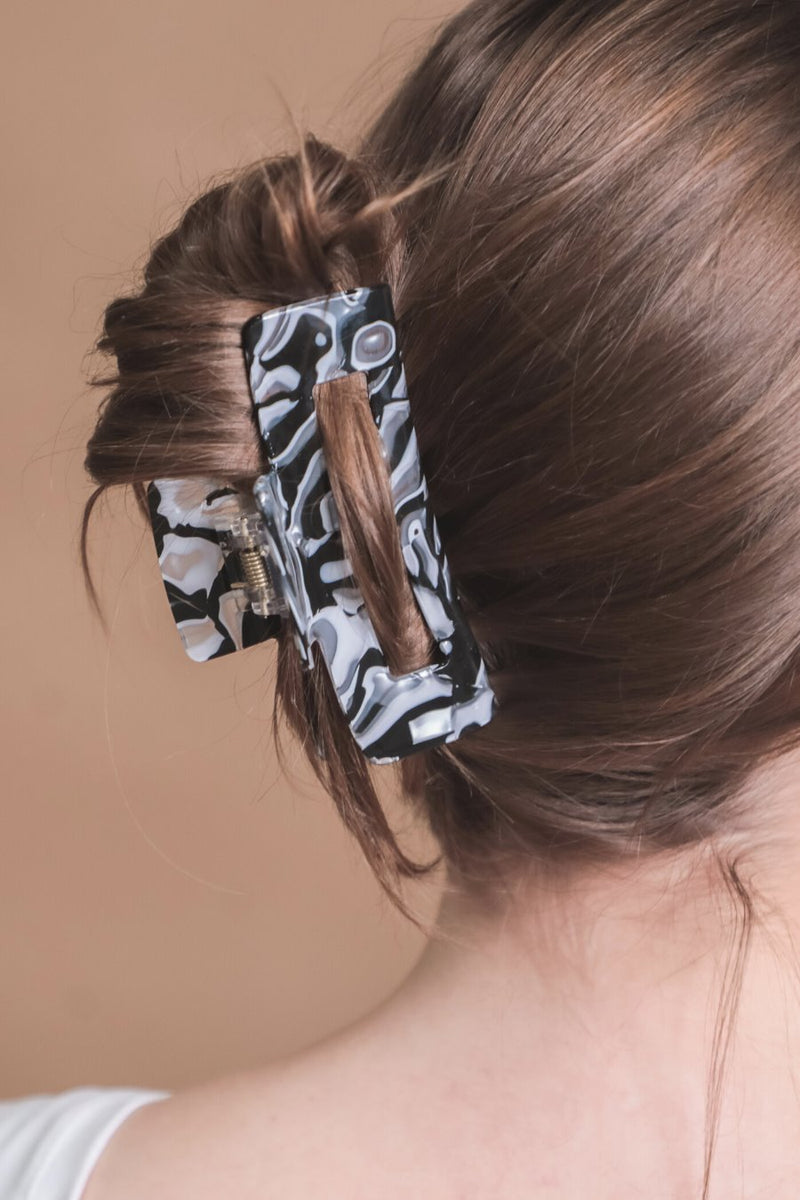 marble acrylic claw clip with a gentle grip that reduces breakage while providing a secure hold in white