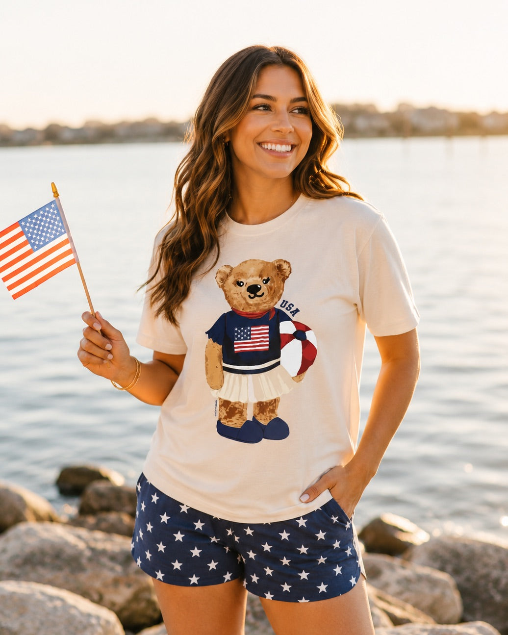 a relaxed-fit beige crew neck tee with a patriotic DTF teddy graphic, short sleeves, standard t-shirt length, unlined construction, and a little stretch that runs large