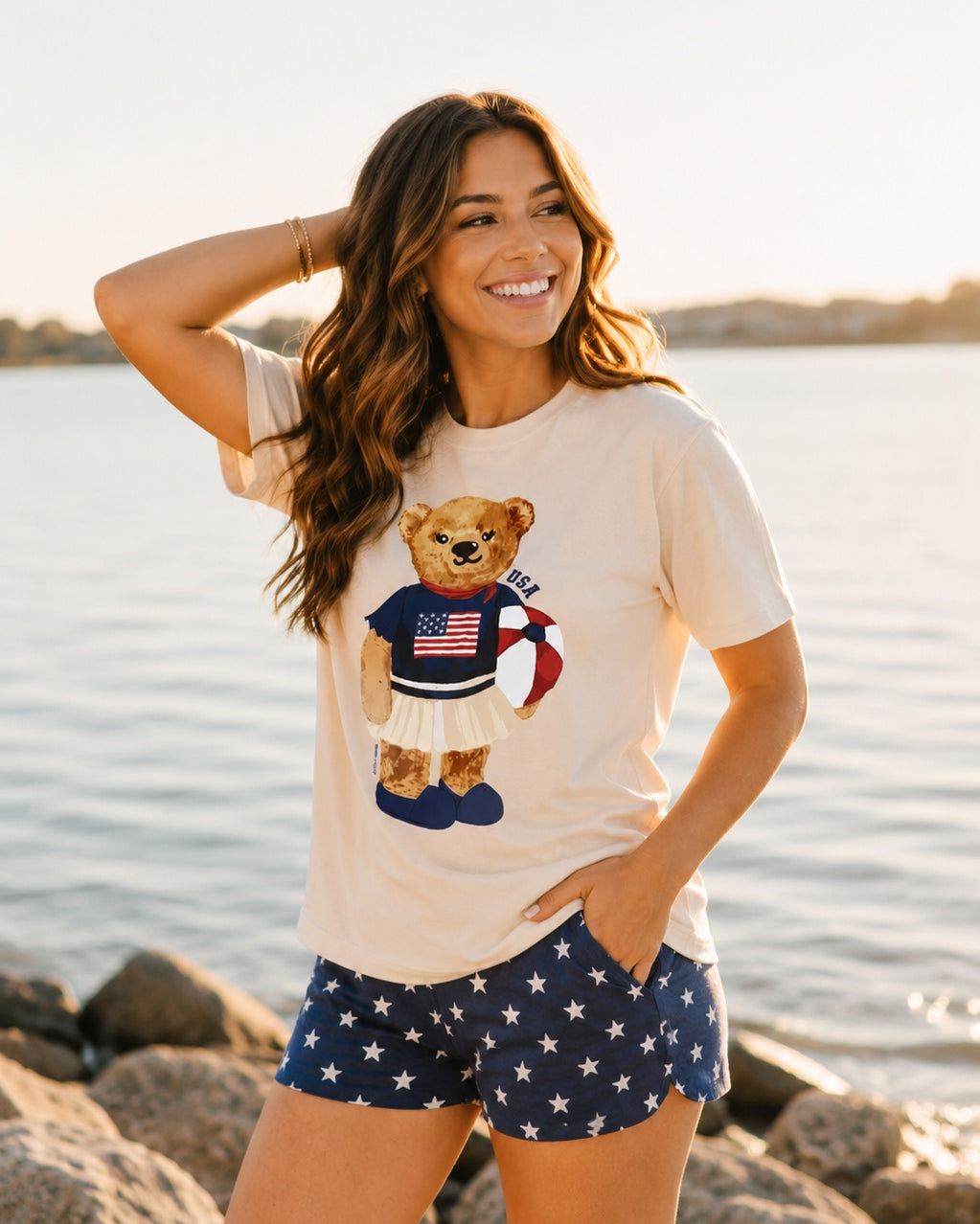 a relaxed-fit beige crew neck tee with a patriotic DTF teddy graphic, short sleeves, standard t-shirt length, unlined construction, and a little stretch that runs large