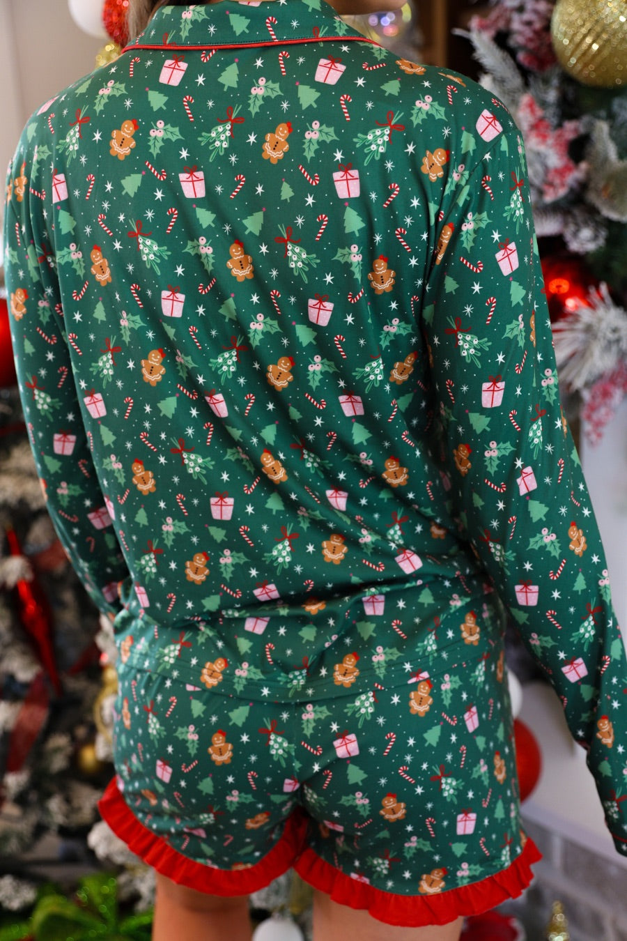 long sleeve top and matching shorts on a custom-designed solid green fabric with a gingerbread girl and a festive holiday print