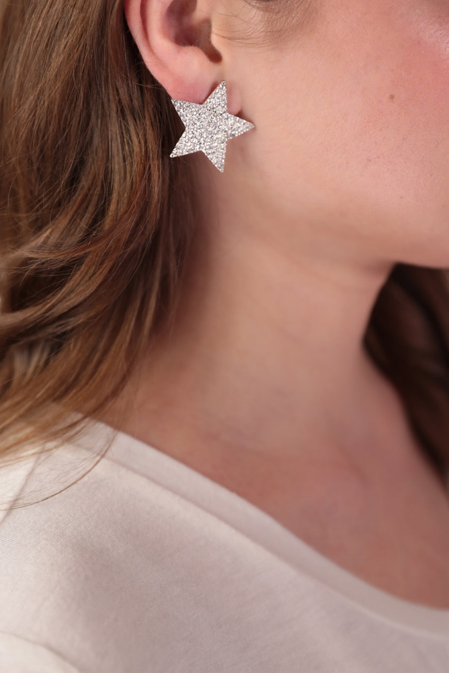 gold plated rhinestone star-shape design with a comfort back earring and plastic disc stopper in silver