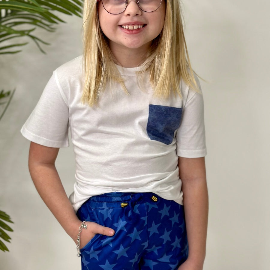 mid-rise relaxed fit activewear shorts with side pockets and a tie waist drawstring with gold bead accents, designed on a blue star-patterned print fabric, royal blue base, and royal blue trims