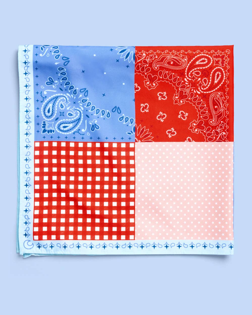 a soft silky polyester scarf with a red, white, and blue quilt-inspired print, finished with a blend of floral, gingham, and paisley details