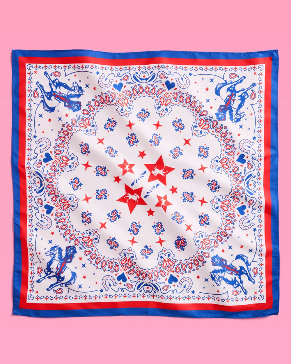 a square bandana with a red, white, and blue western-inspired print, complete with a bold border, cowgirls, hearts, horses, horseshoes, paisley accents, and stars