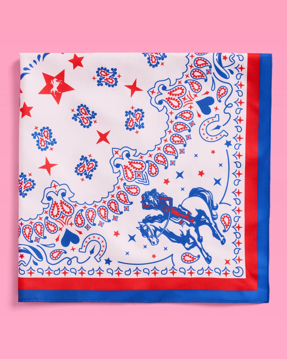 a square bandana with a red, white, and blue western-inspired print, complete with a bold border, cowgirls, hearts, horses, horseshoes, paisley accents, and stars