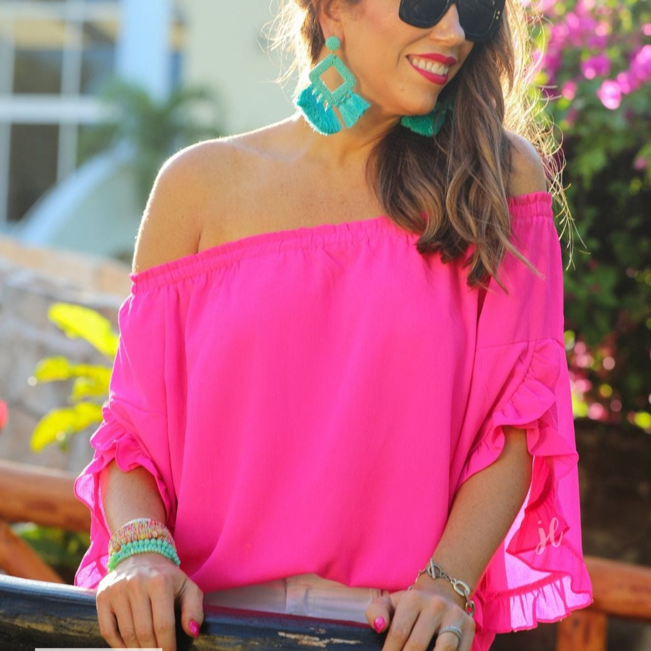 MADE IN USA a flowy style top with a gathered scoop neckline that can be worn on or off the shoulder and three-quarter split ruffle sleeves in pink