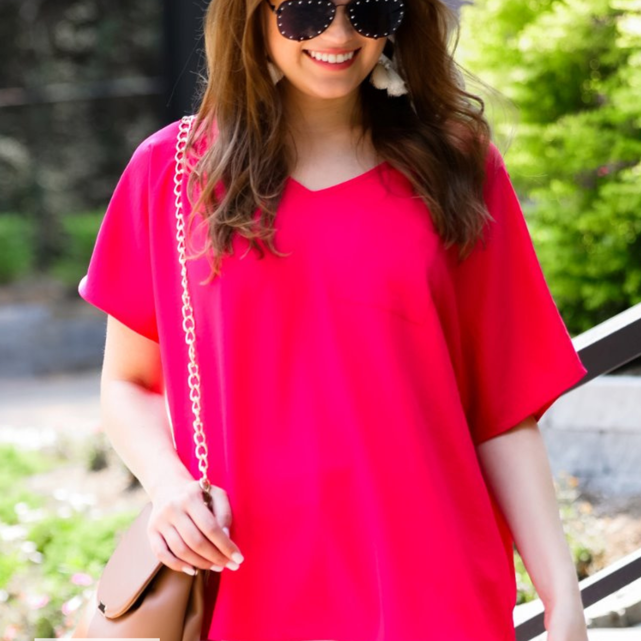 a lightweight magenta short-sleeve woven tunic with a V-neckline, a front chest pocket, and a relaxed, non-stretch silhouette, accented with a MADE IN USA watermark in the bottom left-hand corner