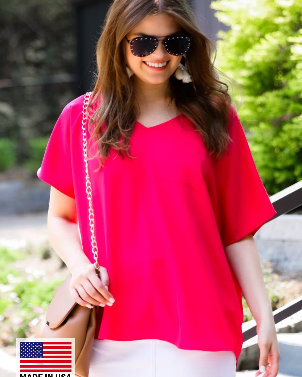 a lightweight magenta short-sleeve woven tunic with a V-neckline, a front chest pocket, and a relaxed, non-stretch silhouette, accented with a MADE IN USA watermark in the bottom left-hand corner