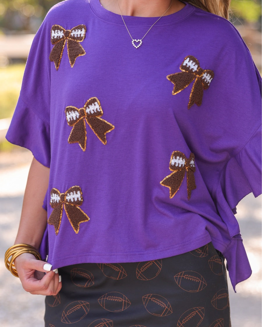 mid-rise relaxed fit everyday skort made of lightweight material with built-in cream shorts, drawstring tie with gold bead accents, an elastic band on the back, and side pockets, designed on an all-over football outline pattern print fabric in black