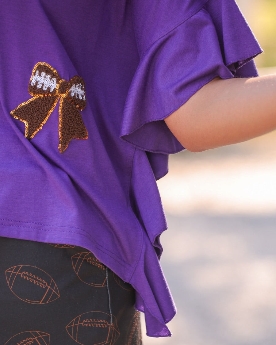 mid-rise relaxed fit everyday skort made of lightweight material with built-in cream shorts, drawstring tie with gold bead accents, an elastic band on the back, and side pockets, designed on an all-over football outline pattern print fabric in black