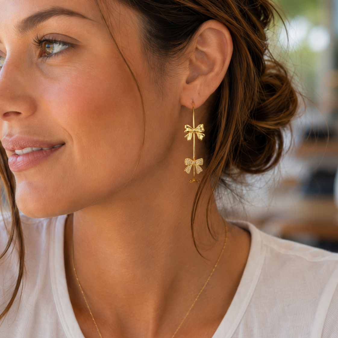 gold hoop post earring with mixed bow accents (two solid, one open, and one rhinestone-detailed designs), finished with a secure gold comfort earring backs-back closure