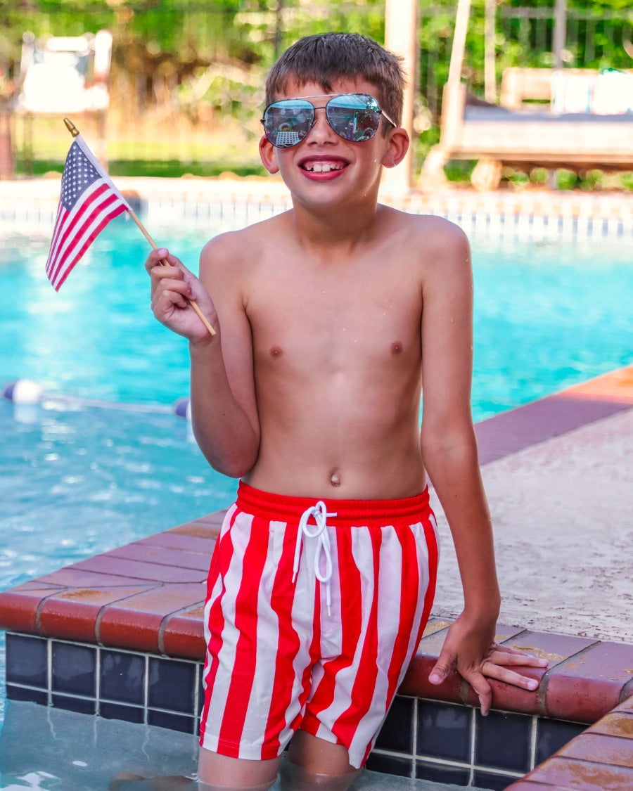 red and white vertical stripe swim trunks with an elastic waistband, drawstring tie, pockets, and built-in mesh underwear