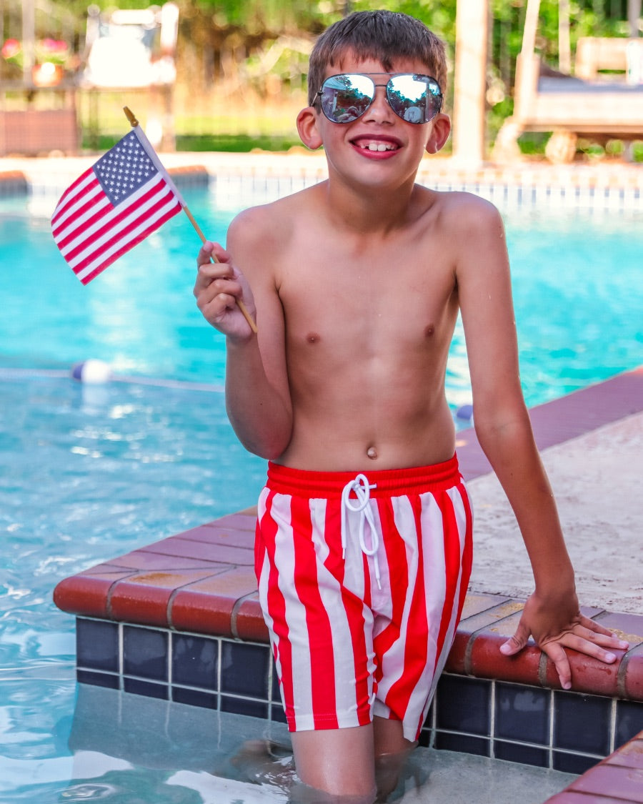 red and white vertical stripe swim trunks with an elastic waistband, drawstring tie, pockets, and built-in mesh underwear