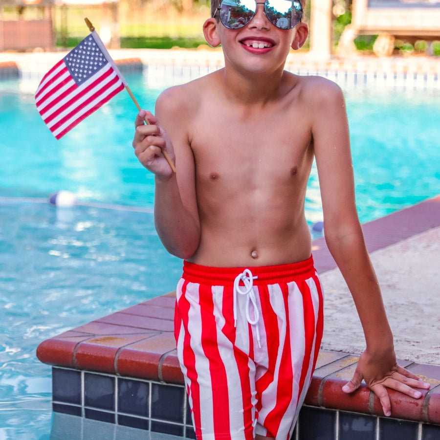red and white vertical stripe swim trunks with an elastic waistband, drawstring tie, pockets, and built-in mesh underwear