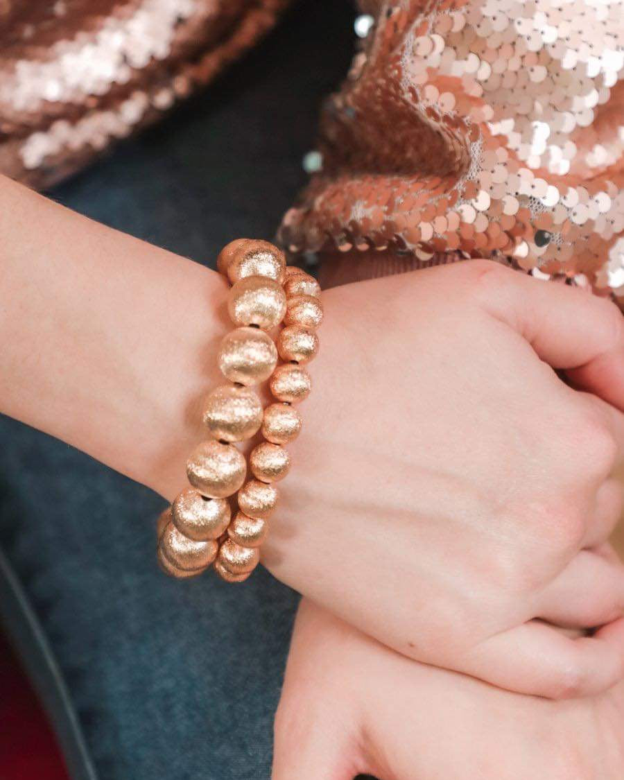 a stackable gold beaded bracelet available in small and large sold separately