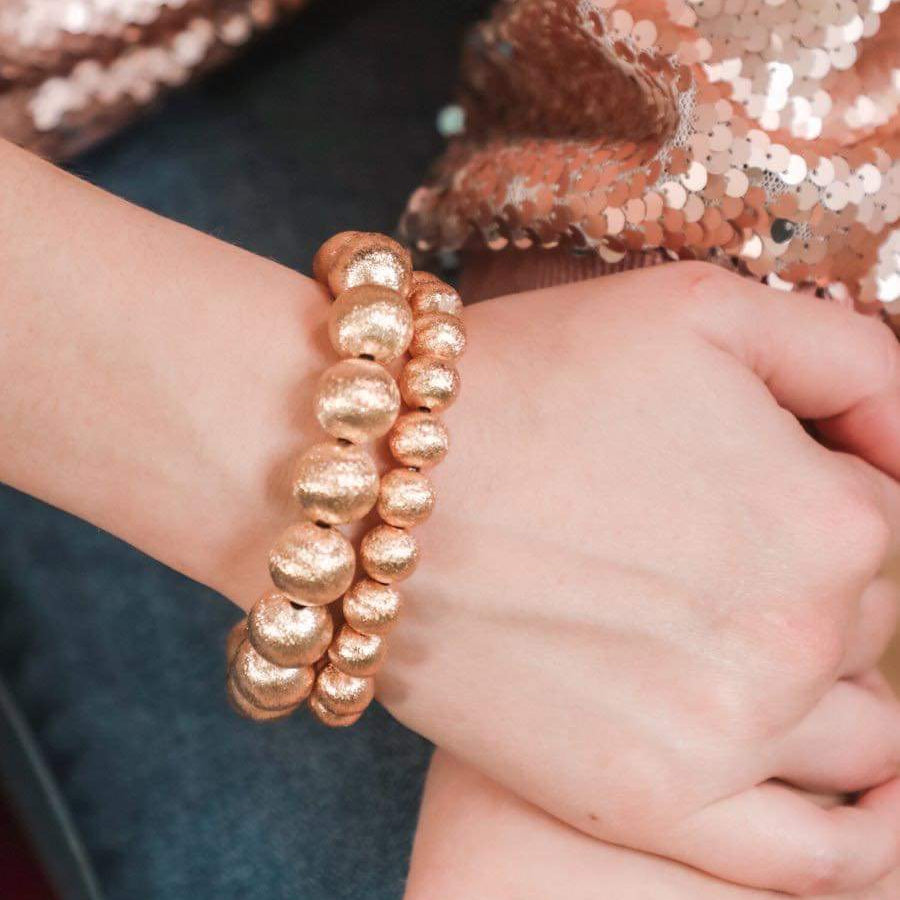 a stackable gold beaded bracelet available in small and large sold separately