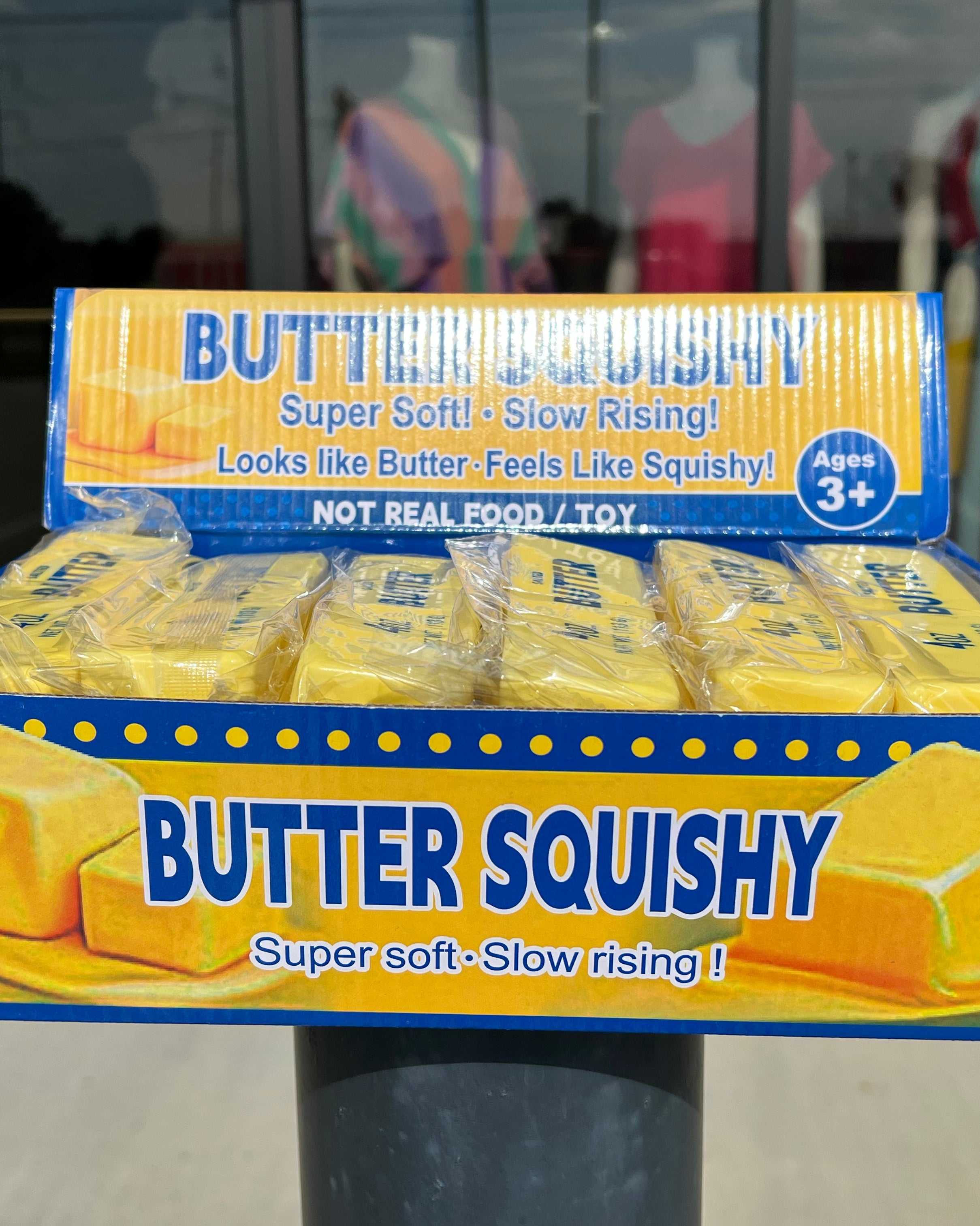 a 4oz yellow butter-stick foam fidget toy made from slow rise polyurethane (PU) foam with a soft texture, classic butter-inspired print, and individual packaging